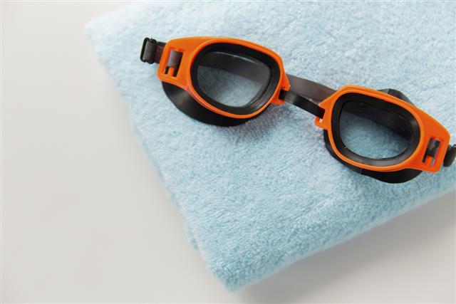 Swimming goggles and towel