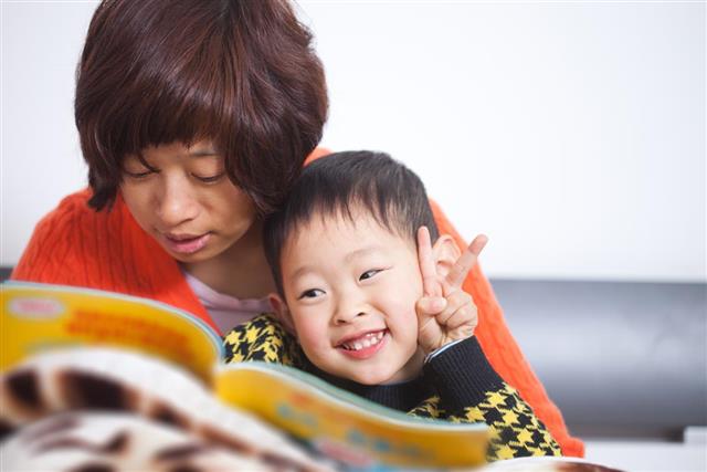 Mother and boy reading book