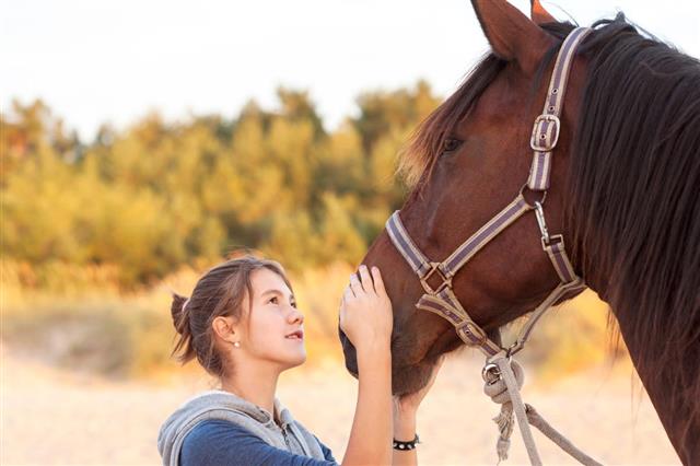 Teen Girl Talking with Horse