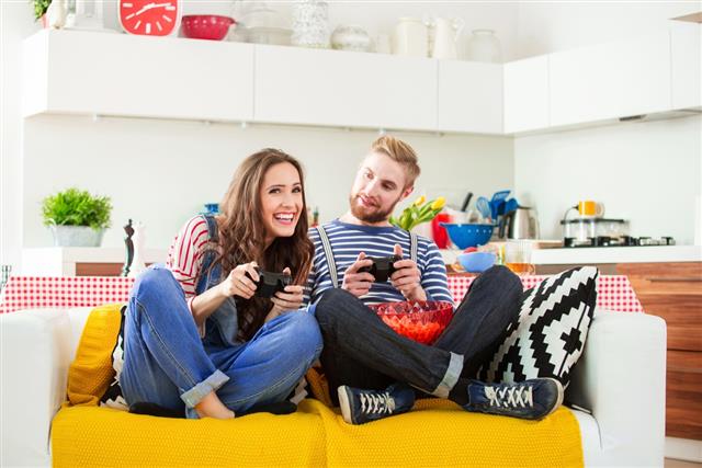 Happy young couple playing play station