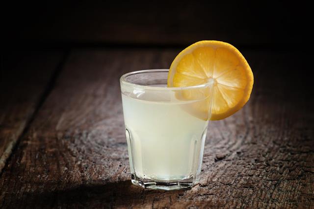 Single glass of vodka with lemon and lemon slice