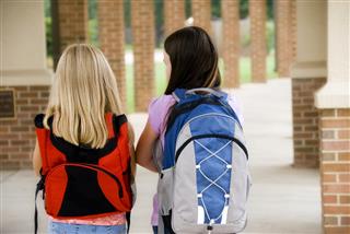 Two young girls walking to school