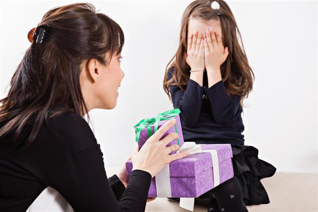 Mother giving her daughter gift