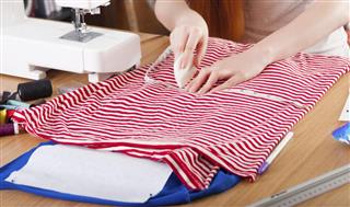 Woman measuring pattern on fabric