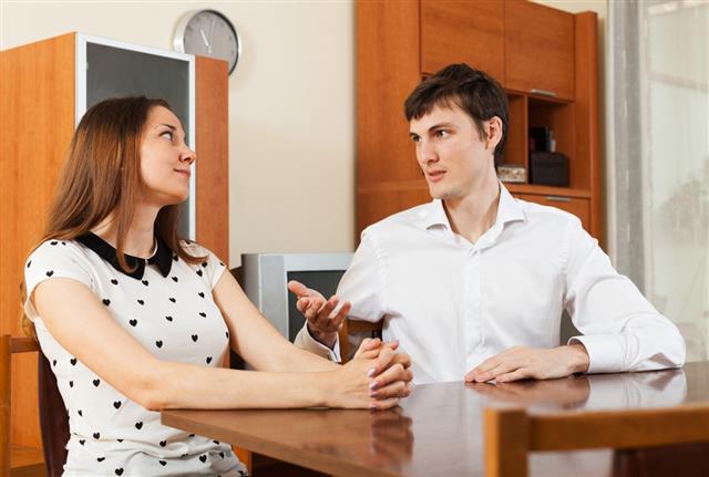 Couple having serious talking at table