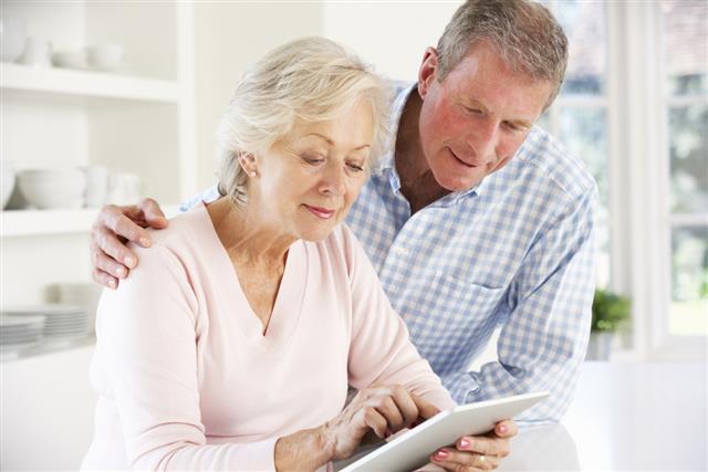Senior couple using tablet at home