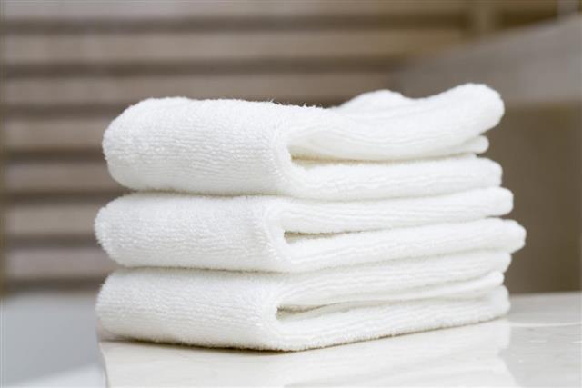 A stack of white spa towels folded