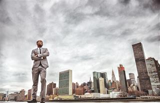Successful business man looking away against the skyline