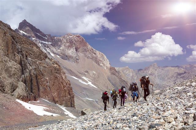 Group of Mountaineer Walking on Deserted Rocky Terrain