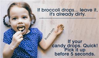 Little girl lying on the floor, smiling, eating lollipop