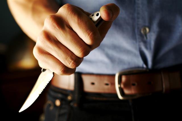 Close-up of man holding a sharp knife