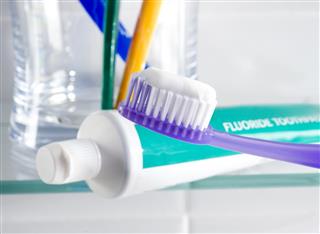 Fluoride toothpaste and toothbrush