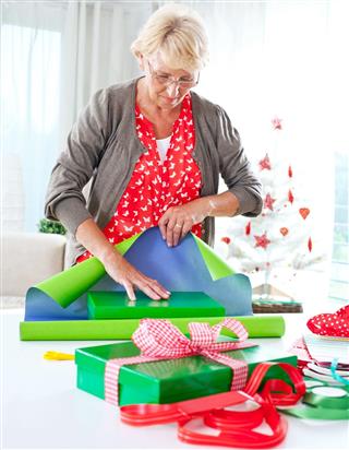 Woman wrapping christmas gifts