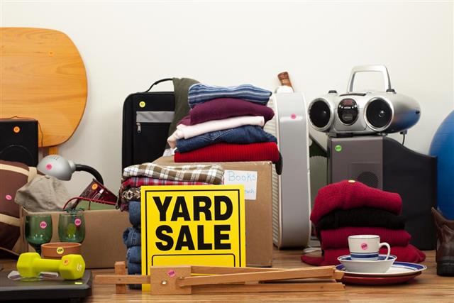 Yard Sale Sign with Household Objects, Clothes, and Electronics