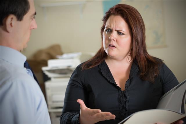 Angry businesswoman arguing with coworker about report or assignment
