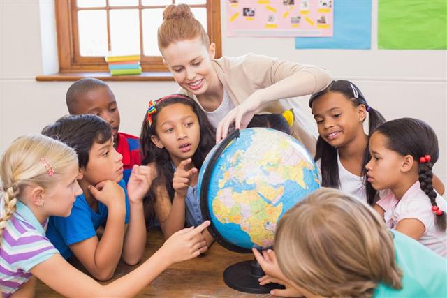 Teacher teaching in classroom with globe