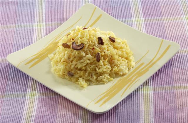 Sweet coconut rice with saffron and dry fruits.