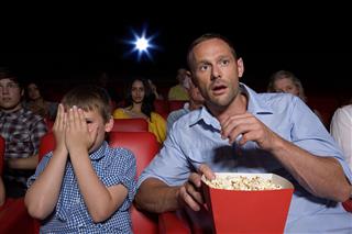 Shocked father and son in movie theater