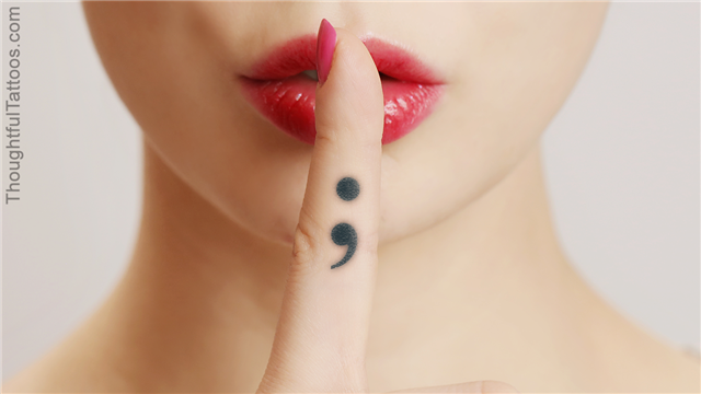 Semicolon tattoo on finger