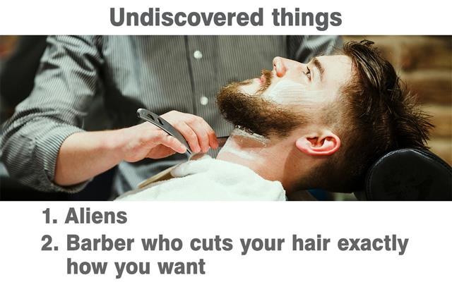 Barber shaving a bearded man