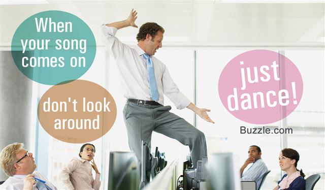 Businessman dancing on desk in cubicle