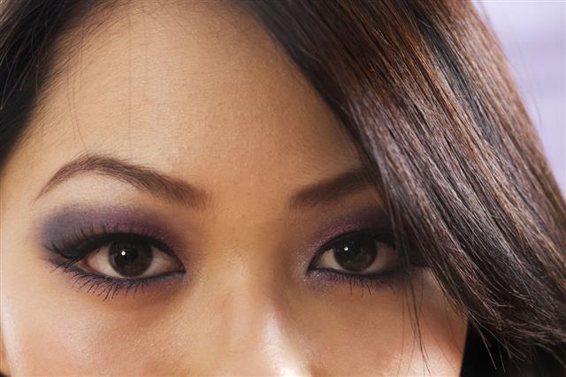Asian woman with blending eyeshadow