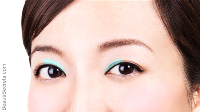 Asian woman with bright blue eyeshadow