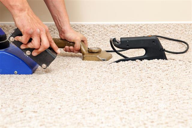 Installer Joining Two Carpet Pieces