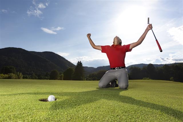 Happy golf player on green