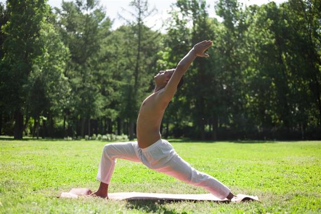 Crescent yoga pose in park