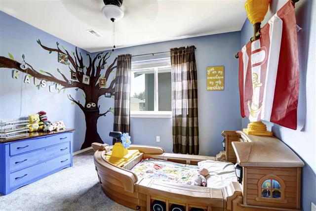 Cheerful kids room with boat bed