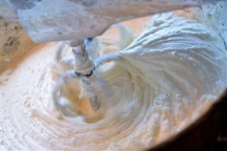 Stand mixer whipping vanilla butter frosting