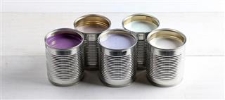 cans with pink, purple, white and lavender paint