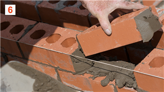 Close Up Of Bricklayer Setting Bricks
