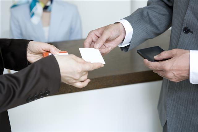 Hands of man handing business card