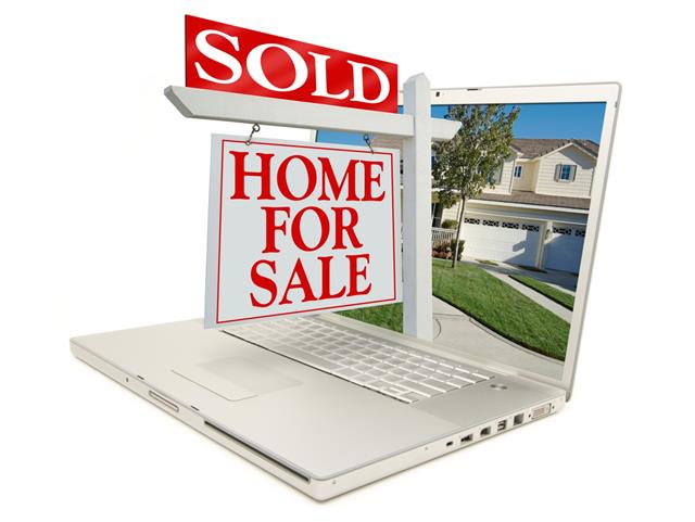 Sold Home for Sale Sign On Laptop