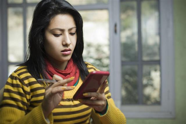 Young woman using phablet
