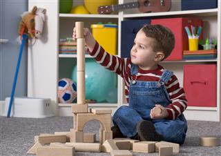 Boy Building Tall Wooden Toy