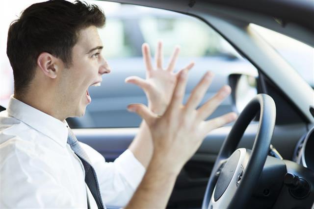 Frustrated man driving car