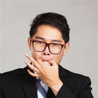 Asian businessman with beer whistle with fingers