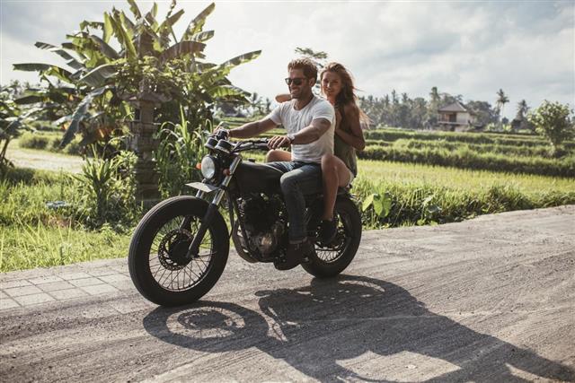 Young couple riding motorbike