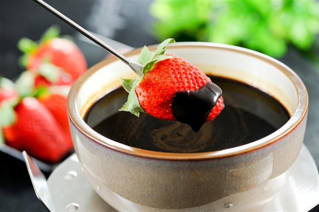 Close-up of strawberry dipped in chocolate fondue