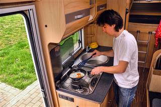Man cooking in camper