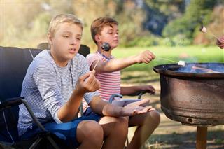 boys roasting marshmallows