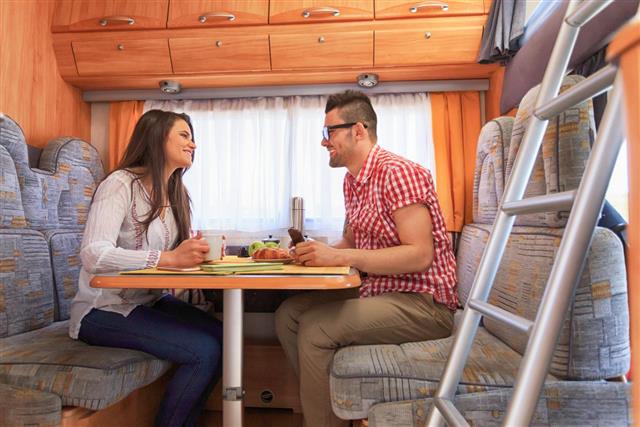 couple sitting inside a caravan