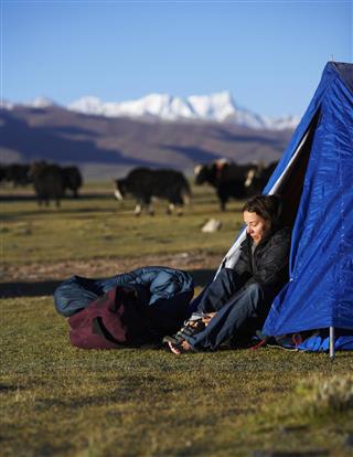 Woman in camping tent
