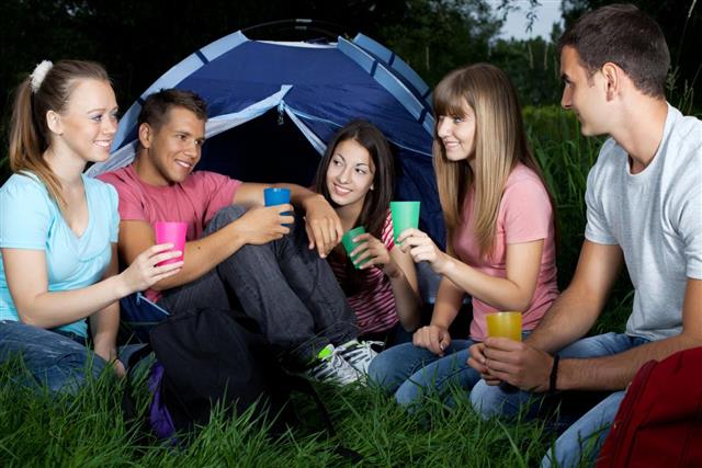 teenagers sitting in camp