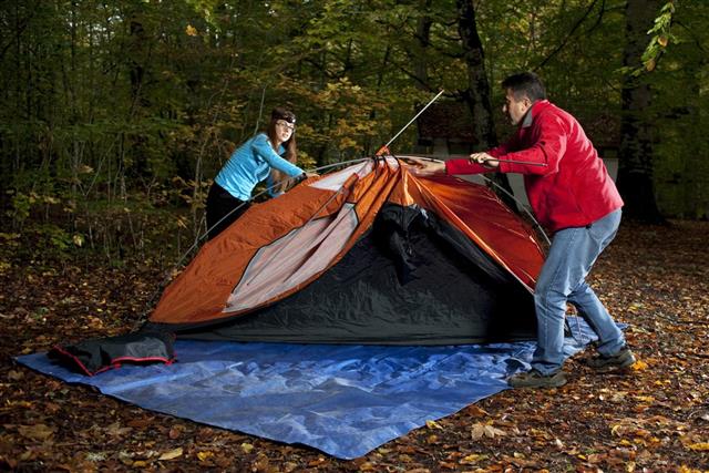 couple building a tent