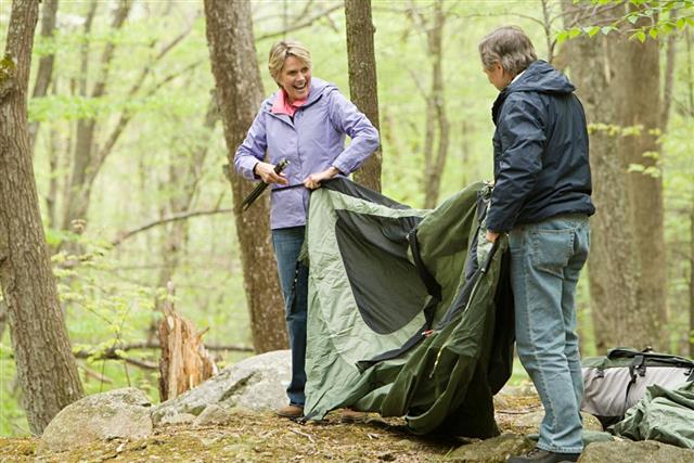 couple setting up a tent