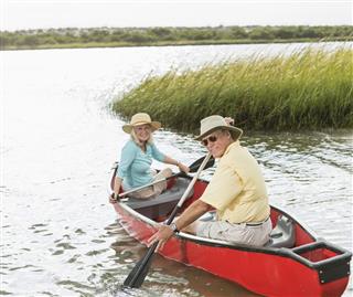 Senior Couple Sitting In Canoe